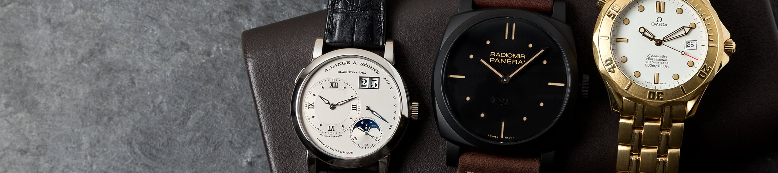 3 watches on brown leather box